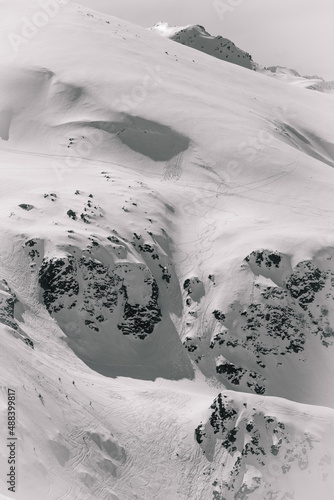 Ski tracks in the snow on the big mountain photo