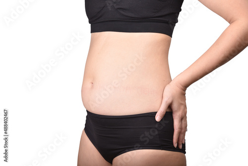 Fat woman standing and showing belly fat, Overweight obesity woman, Woman muffin top waistline.