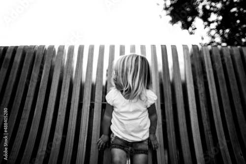 mysterious portrait of young girl against wood slats. photo