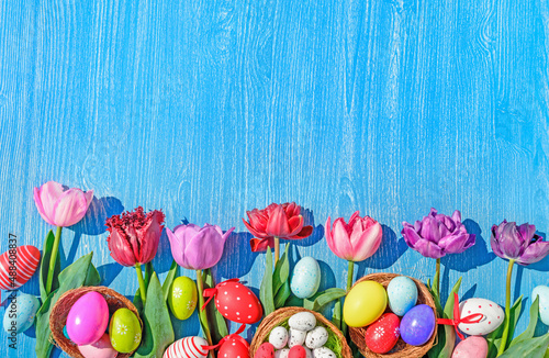 eggs and tulips easter wooden background