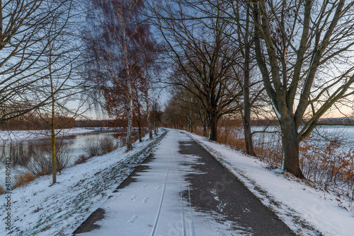 Asphalt path for bikes near Ceske Budejovice city in winter snowy morning
