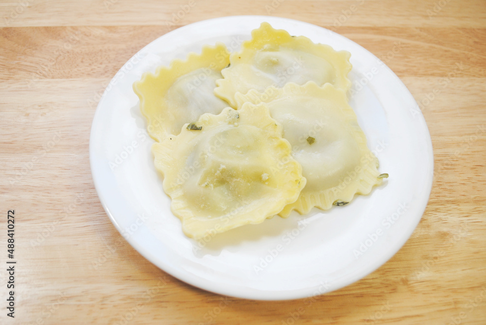 Four Appetizing Large Spinach Raviolis on a White Plate Four Appetizing Large Spinach Raviolis on a White Plate