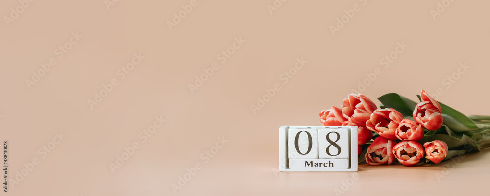 International women's day or eight march banner with copy space. 8 march date on perpetual calendar and bunch of red tulip on beige champagne background. Long horizontal banner - obrazy, fototapety, plakaty 