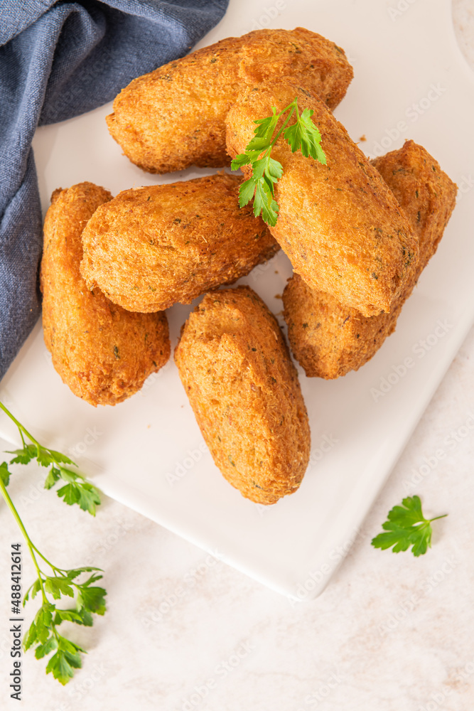 Bolinhos de bacalhau, very famous in Portuguese gastronomy. Fried dumpling, cod dumpling, fish meat, salted cod fritters, bacalao bunuelos. Bolinhos de bacalhau, very famous in Portuguese gastronomy. Fried dumpling, cod dumpling, fish meat, salted cod fritters, bacalao bunuelos.