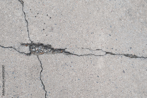 Macro shooting of big crack on light asphalt road