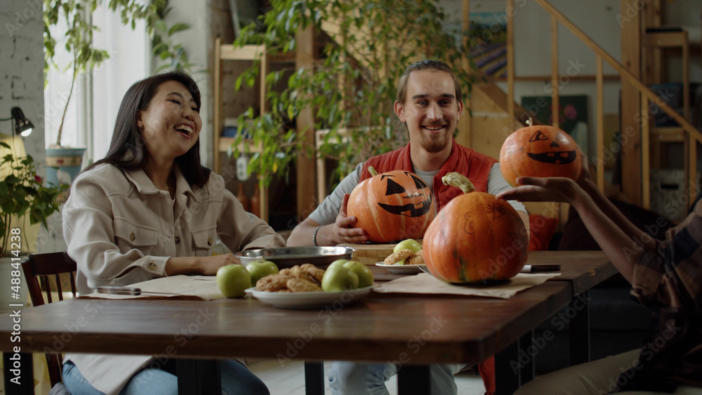 Fototapeta premium Young ladies exchange their handmade pumpkins and talk