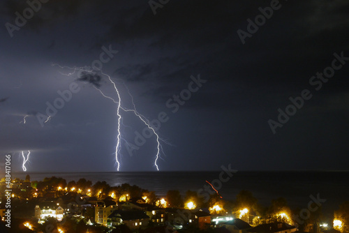 lightning over the sea in the night sky 