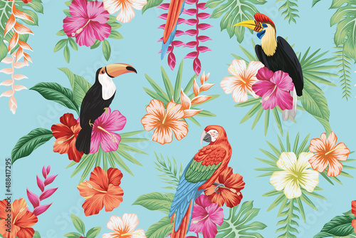 Tropical vintage toucan, parrot macaw, red magenta yellow hibiscus flower, palm leaves floral seamless pattern blue background. Exotic jungle wallpaper. © good_mood