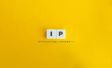 Intellectual property (IP) Banner. Letter Tiles on Yellow Background. Minimal Aesthetics.