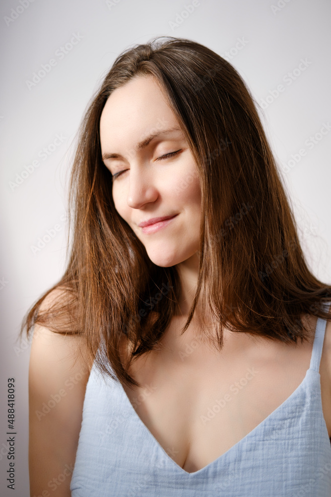 authentic portrait of caucasian brunette woman with closed eyes without makeup in blue T-shirt, mature woman, natural beauty authentic portrait of caucasian brunette woman with closed eyes without makeup in blue T-shirt, mature woman, natural beauty