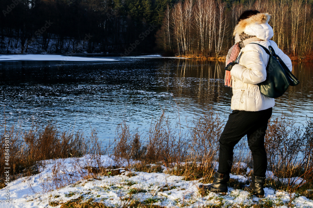 Portrait of a woman against the background of the river and forest in winter. Portrait of a woman against the background of the river and forest in winter.