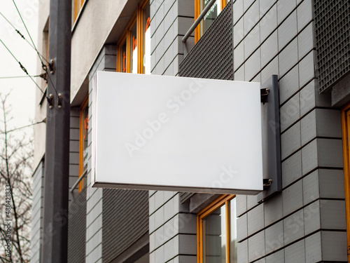 Empty display on a facade of a business inside the building. Template for testing a logo or a sign next to a wall. Blank mockup to advertise a brand. Signboard of a cafe a restaurant or an office.