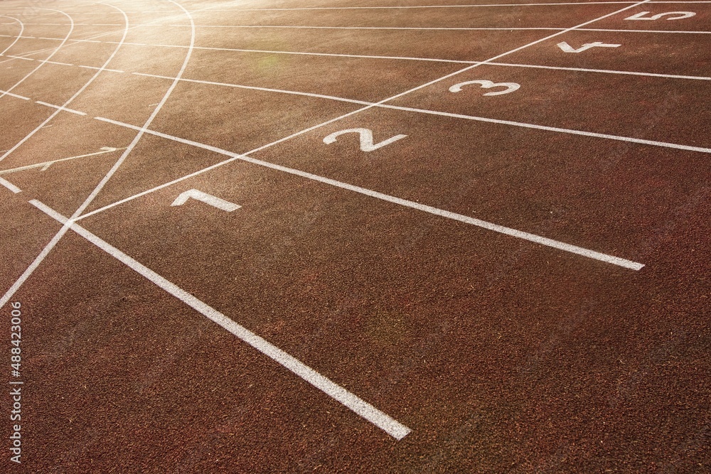Starting and finishing lines on a running track, including track numbering. Red tartan and white colors.