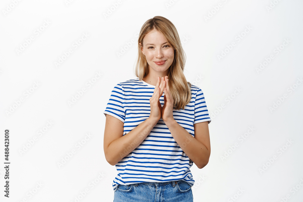 Thoughtful young girl, student thinking, steeple fingers, scheming, has an idea, plan to do smth devious, stands over white background Thoughtful young girl, student thinking, steeple fingers, scheming, has an idea, plan to do smth devious, stands over white background