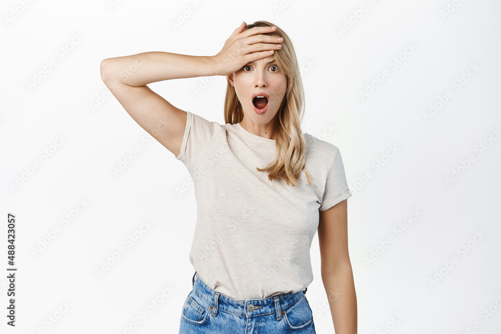 Shocked young woman forgot, remember smth, slap forehead and gasping startled, realize something, standing over white background Shocked young woman forgot, remember smth, slap forehead and gasping startled, realize something, standing over white background