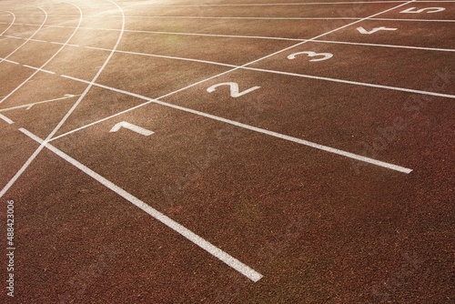 Starting and finishing lines on a running track  including track numbering. Red tartan and white colors.