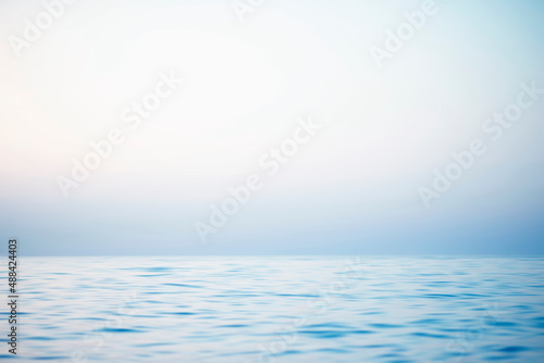 Abstract sunset sky and ocean nature background with blurred panning motion.