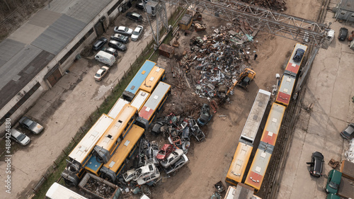 Scrap Metal Junkyard With Working Excavator