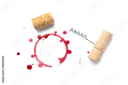 Red wine ring, drops, bung and corkscrew on white background, top view