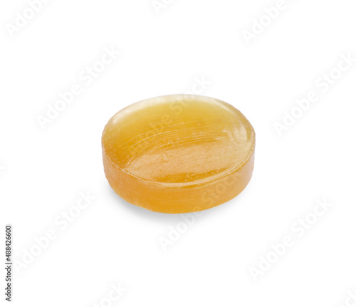 One yellow cough drop isolated on white