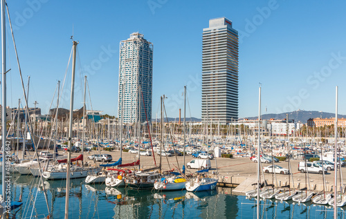 Photography Barcelona towers captured during a sunny day between boats