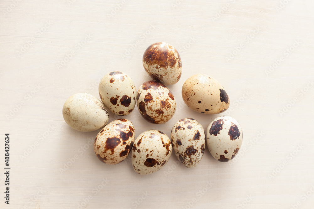 quail eggs arranged on white wooden background quail eggs arranged on white wooden background