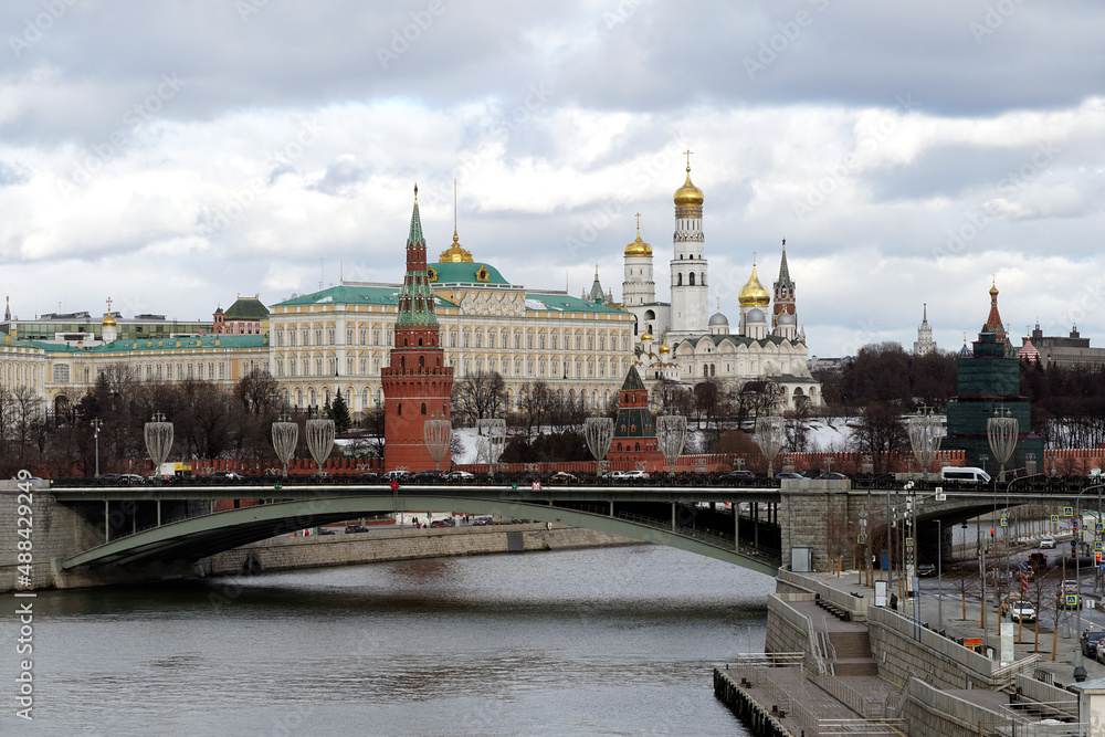 view of the moscow kremlin, the moscow river and the big stone bridge in cloudy weather