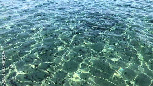 Play of light on transparent beautiful green waves of the Mediterranean Sea