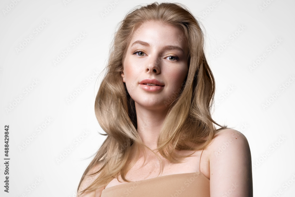 Pretty young beautiful woman with blond shiny hair. Girl with natural makeup and beauty. Cosmetology and dermatology advertising Pretty young beautiful woman with blond shiny hair. Girl with natural makeup and beauty. Cosmetology and dermatology advertising