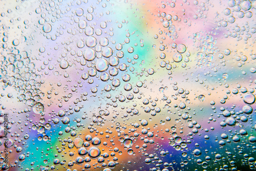 Bubbles in oil in water on a rainbow abstract macro background.