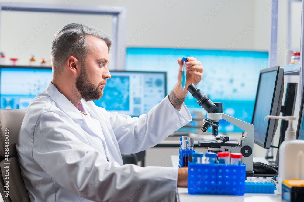 Professional scientist is working on a vaccine in a modern scientific research laboratory. Genetic engineer workplace. Future technology and science. Professional scientist is working on a vaccine in a modern scientific research laboratory. Genetic engineer workplace. Future technology and science.