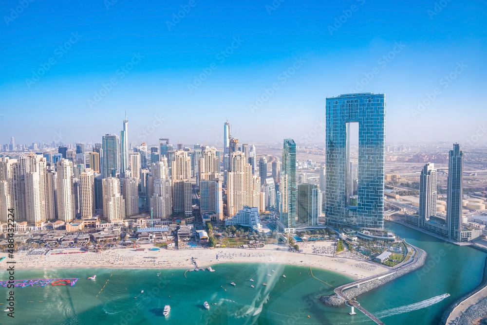 Aerial view of the Dubai Marina and JBR area from the famous Ferris Wheel and golden sand beaches in the Persian Gulf. Holidays and vacations in the UAE