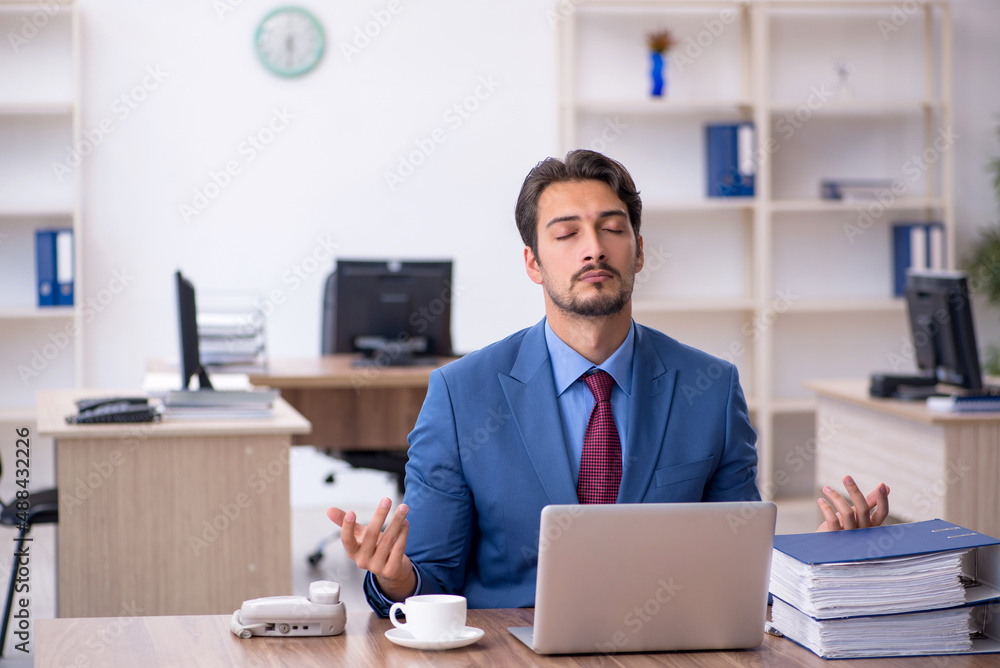 Young male employee working in the office