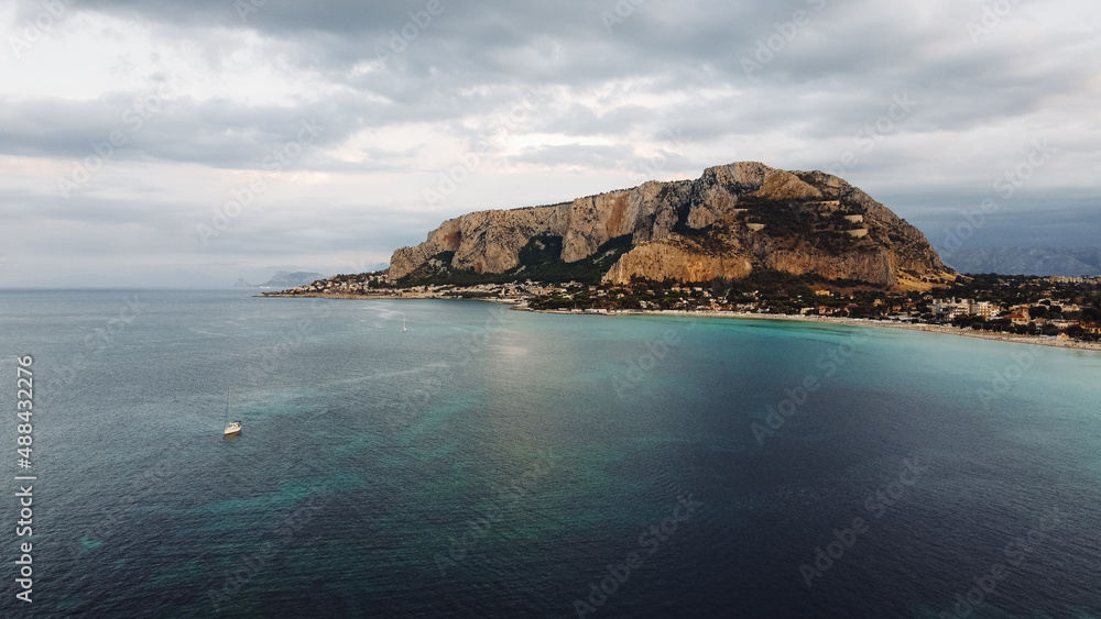 Drone shot of a bay with cliffs and mountains. Bay in Italy. Aerial view of Mondello Beach bay, Palermo, Sicily. Drone shot of a bay with cliffs and mountains. Bay in Italy. Aerial view of Mondello Beach bay, Palermo, Sicily.