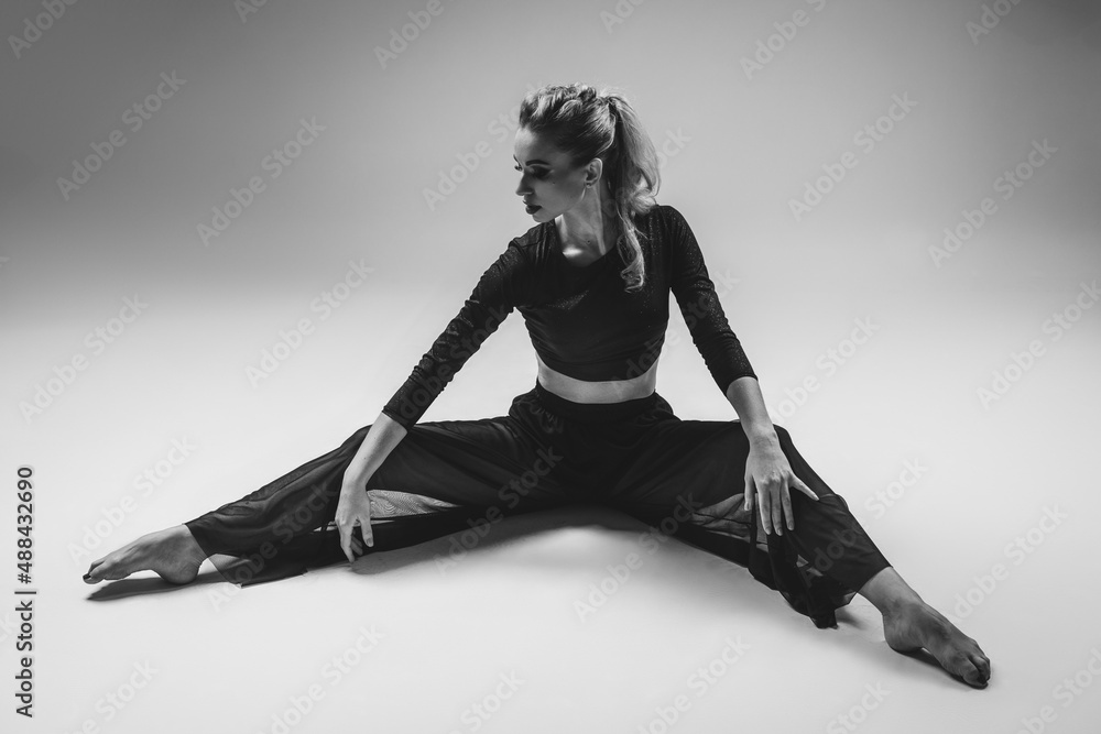Young and stylish modern dancer on gray studio background Young and stylish modern dancer on gray studio background