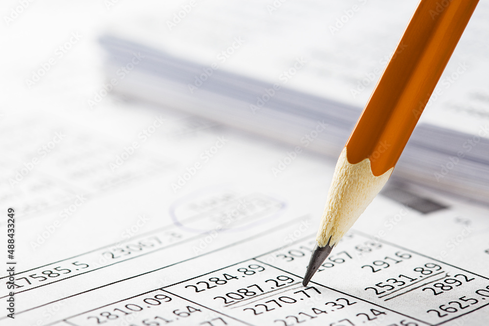 Accounting document with pencil and checking financial chart. Concept of banking, financial report and financial audit. Accounting document with pencil and checking financial chart. Concept of banking, financial report and financial audit.