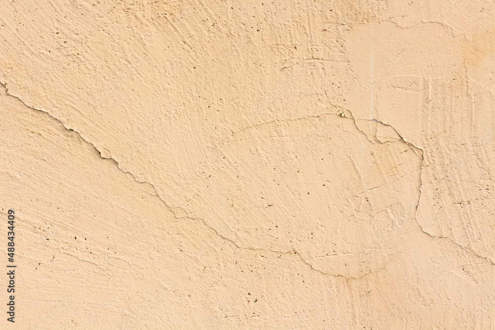 Obraz premium Beige sand color horizontal cracked background.