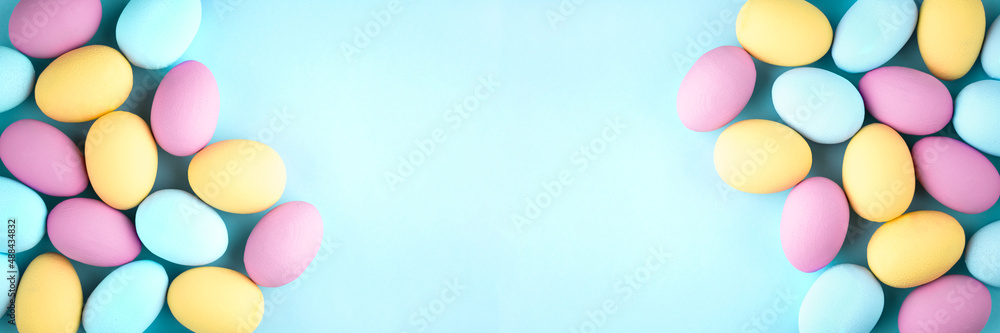 Lots of colorful eggs on a blue background with copy space. Easter banner. Lots of colorful eggs on a blue background with copy space. Easter banner.