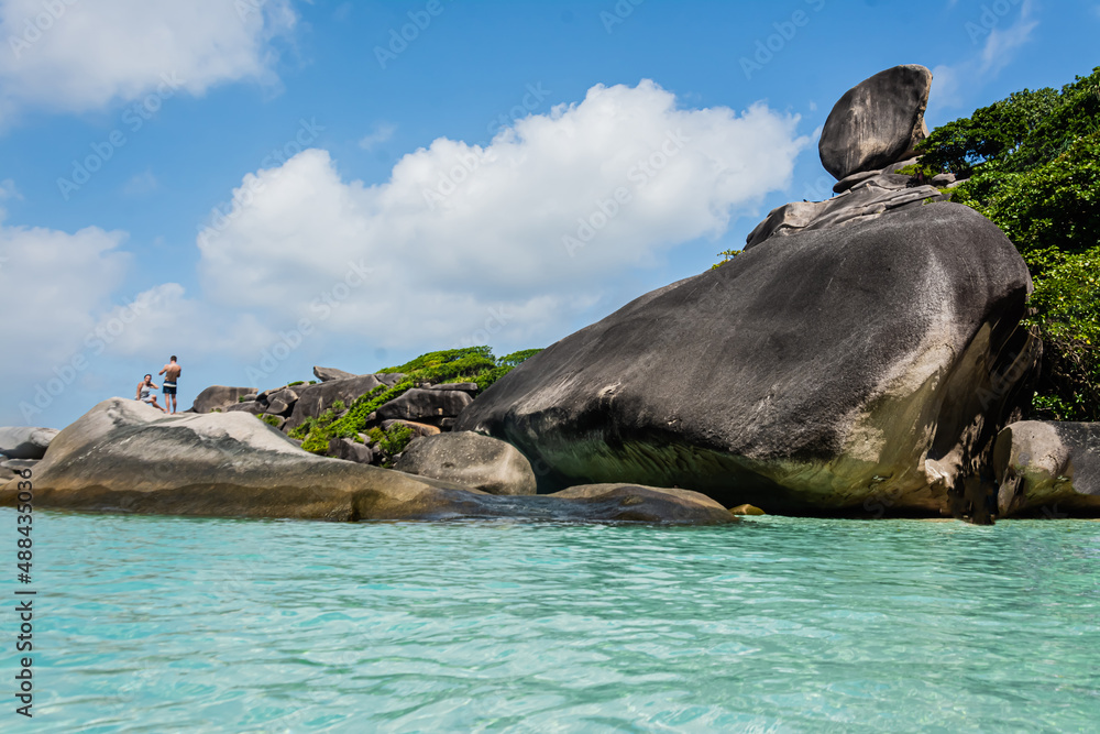 Fototapeta premium Beautiful landscape people on rock is a symbol of Similan Islands, blue sky and cloud over the sea during summer at Mu Ko Similan National Park, Phang Nga province, Thailand