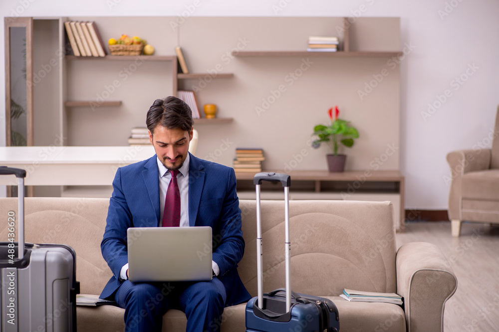 Young businessman preparing for trip at home Young businessman preparing for trip at home