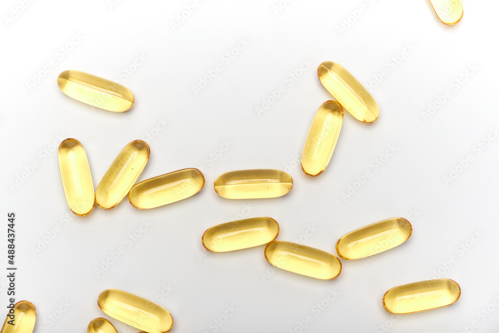 yellow transparent medicinal capsules on a white background yellow transparent medicinal capsules on a white background