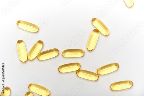 yellow transparent medicinal capsules on a white background