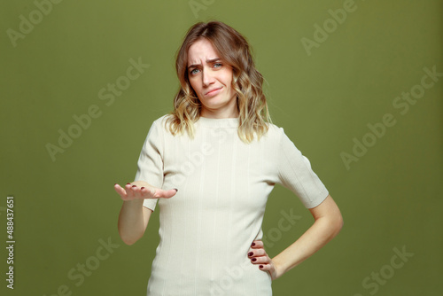 Frowning dissatisfied young woman showing so-so gesture. Questionable choice. Unsuitable options concept