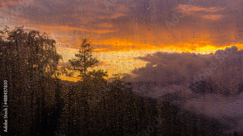 glass with raindrops at sunset in the summer in the mountains © m.lexandrovna