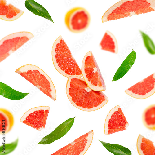 Background of their grapefruit slices and green leaves on a white background.
