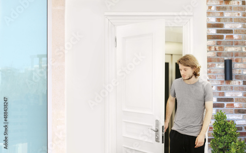man opening the door of his home.