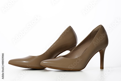 leather beige high heel shoes on a white background