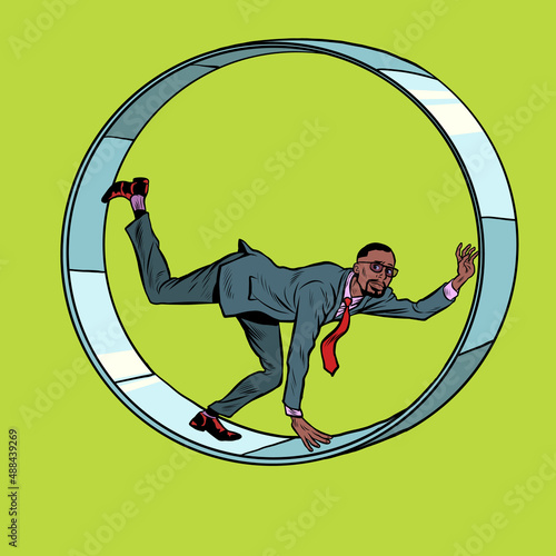 african businessman in a squirrel wheel. Routine monotonous work. A man in captivity of his affairs