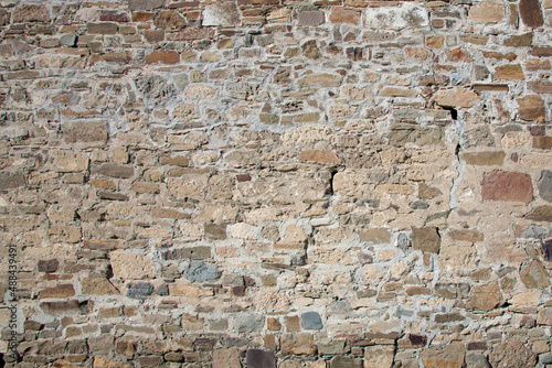 Close-up of a fragment of an old natural white limestone wall.