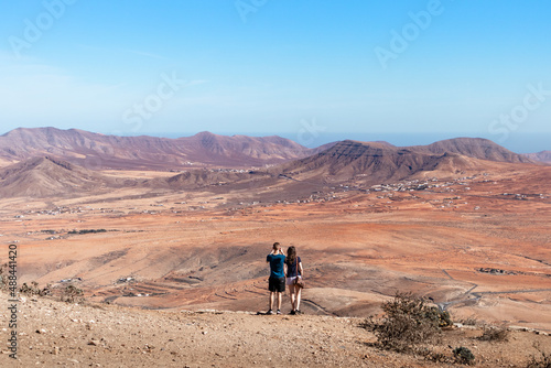 Tourists taking pictures of the dry landscape in Fuerteventura, Canary Islands, Spain